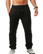 Pantalon de jogging noir pour homme, taille élastique, poches latérales, style décontracté, idéal pour sport et détente, porté avec baskets grises.