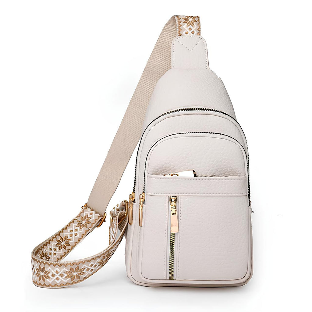 Sac à bandoulière en cuir blanc avec sangle brodée beige, poches zippées dorées. Accessoire mode élégant et pratique pour femme.