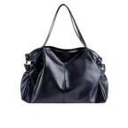 Sac à main en cuir noir élégant avec anses longues, design moderne et spacieux. Accessoire mode femme, idéal pour un look chic et sophistiqué.