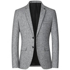 Veste homme élégante en tweed gris, coupe ajustée, deux boutons, poches à rabat, idéale pour tenues formelles et professionnelles.