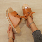 Faux leather wedge sandal with bow