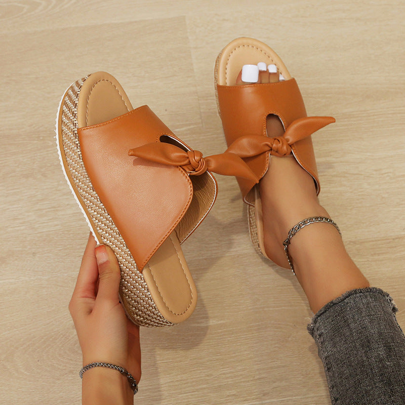 Faux leather wedge sandal with bow