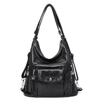 Sac à main en cuir noir élégant avec bandoulière, poches zippées et détails métalliques. Accessoire mode femme chic et pratique.