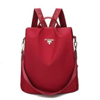 Sac à dos rouge élégant en nylon avec logo doré, bretelles ajustables et bandoulière amovible. Accessoire mode femme tendance et pratique.