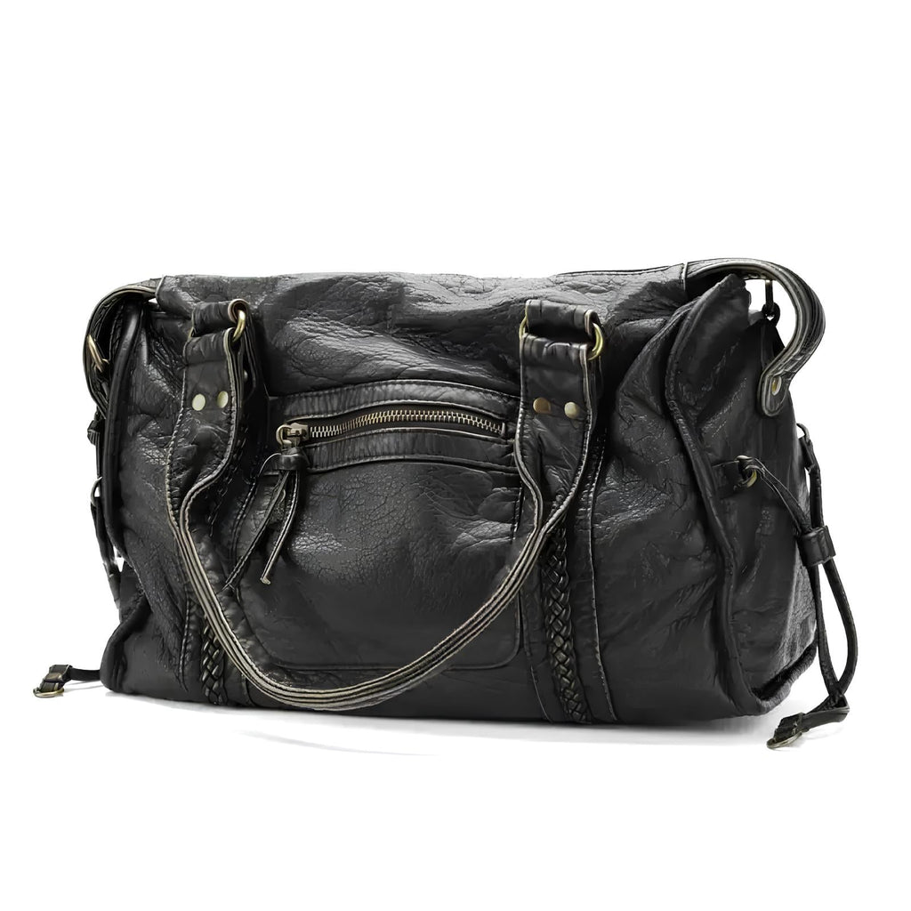 Sac à main en cuir noir élégant avec poches zippées, anses robustes et détails tressés. Accessoire mode femme chic et pratique.