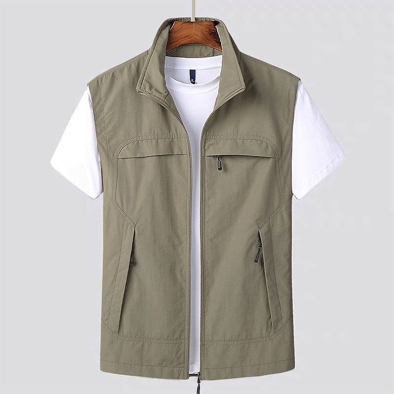 Gilet sans manches kaki pour homme sur cintre, avec fermeture éclair, poches zippées, porté sur t-shirt blanc. Mode masculine, vêtement décontracté.
